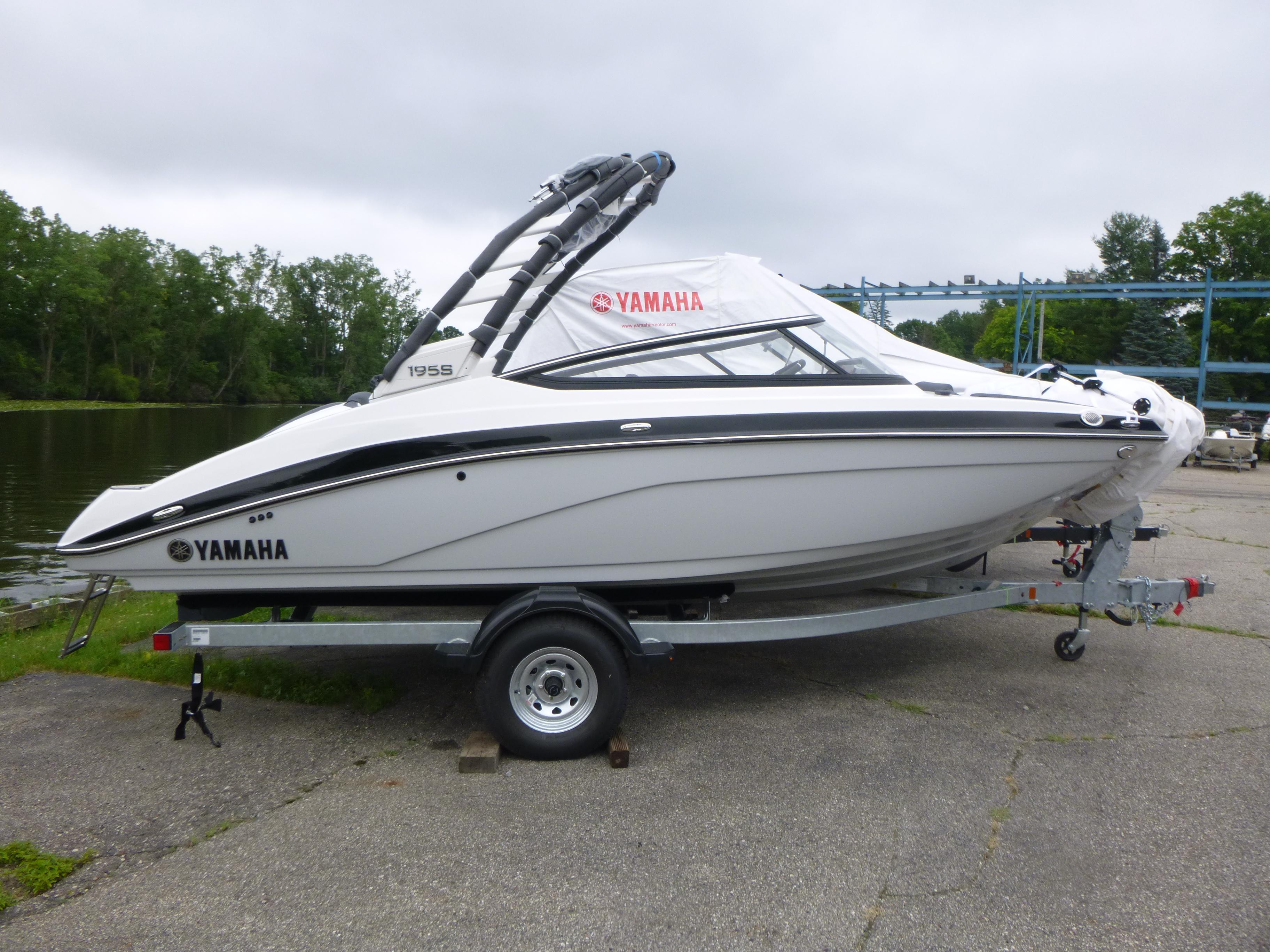 Yamaha Boats 195S 2025 Yamaha Boats 195S on trailer by a lake, ready for launch.