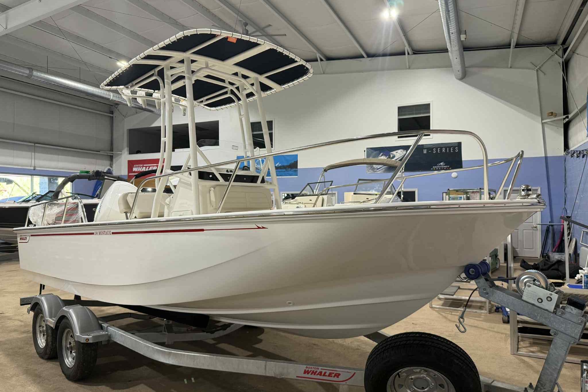 Boston Whaler 190 Montauk 2026 Boston Whaler 190 Montauk boat on trailer in showroom.