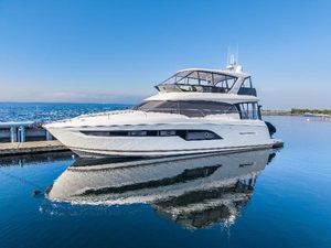 Prestige 630 2018 Prestige 630 yacht docked on calm water under clear blue sky.