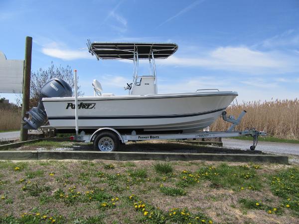 Parker 18SE Center Console 2025 Parker 18SE Center Console boat on trailer, parked outdoors under blue sky.