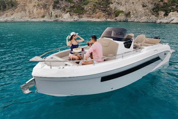 Ranieri 275 SL 2025 Ranieri 275 LS boat on clear blue water with people enjoying a sunny day.
