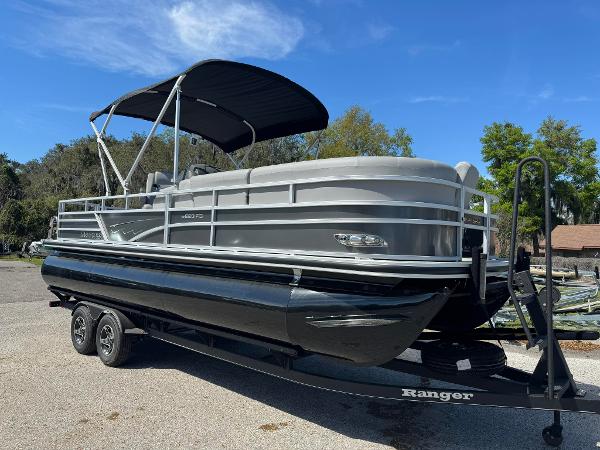 Ranger Reata 223FC 2024 Ranger Reata 223FC pontoon boat on a trailer with a black canopy.