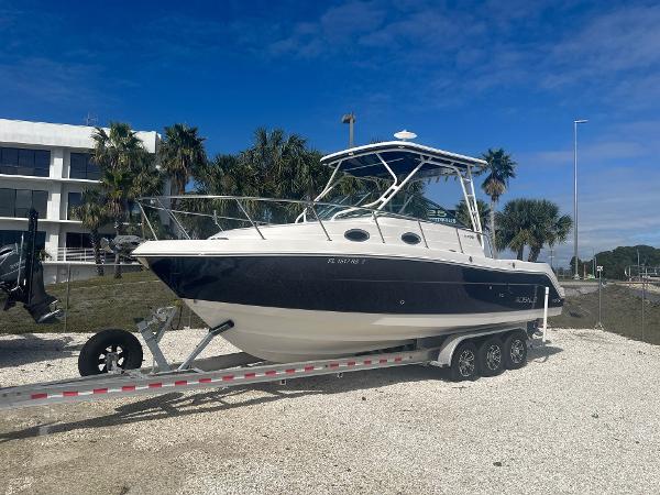 Robalo R305 Walkaround 2018 Robalo R305 Walkaround boat on trailer, parked outdoors under blue sky.