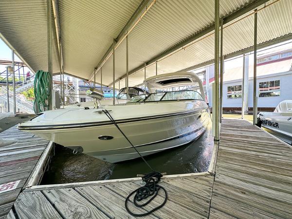 Sea Ray SLX 310 Outboard 2023 Sea Ray SLX 310 Outboard docked under a covered marina.