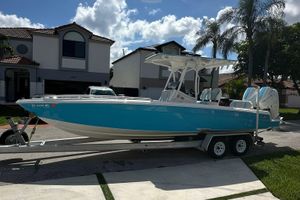 Concept 27' CC 2019 Concept 27' CC boat on trailer, parked in residential area under clear sky.