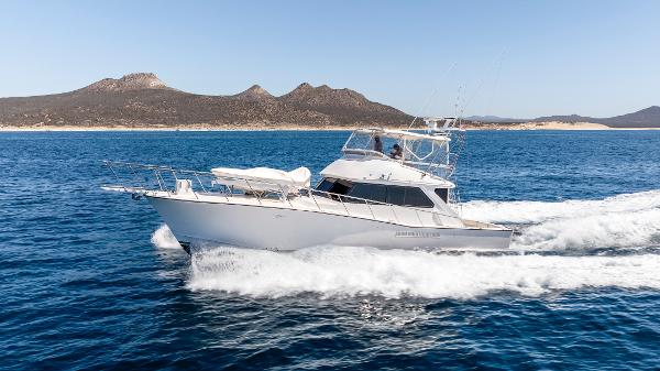 Pacifica 50 Convertible 1983 Pacifica 50 Convertible yacht cruising on open sea with scenic mountain backdrop.