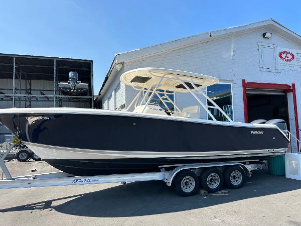 Pursuit S 280 Sport 2014 Pursuit S 280 Sport boat on a trailer outside a warehouse.