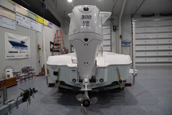 Contender 26 Bay 2024 Contender 26 Bay boat with 300 V6 engine in a showroom.