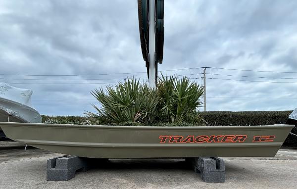 Tracker Grizzly 1236 Utility 2025 Tracker Grizzly 1236 Utility boat with plants, displayed outdoors on blocks.