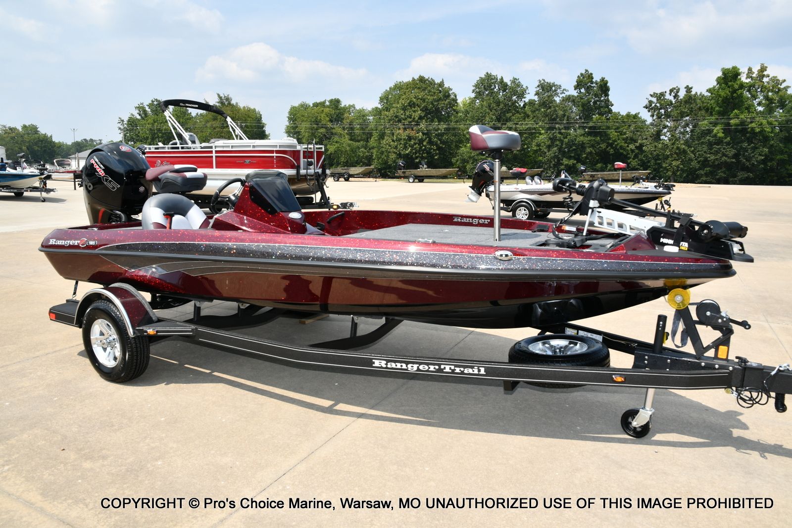 Ranger Z185 2026 Ranger Z185 boat on trailer, parked outdoors, featuring sleek design and maroon color.