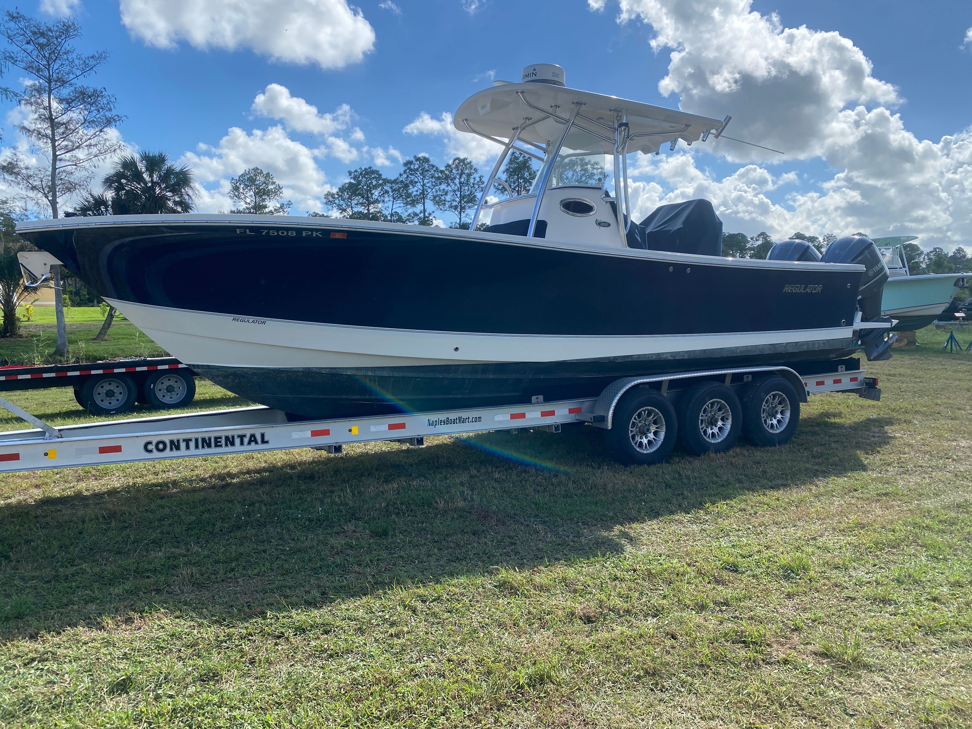 Regulator 28 2013 Regulator 28 boat on a Continental trailer under a blue sky.