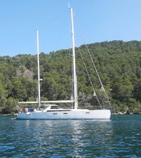 Amel 64 Sailing yacht Amel 64, 2014 model, anchored near lush green forest.