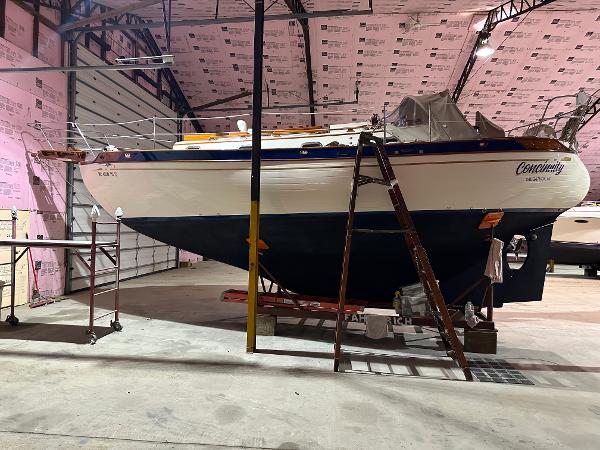 Baba 30' Cutter 1985 Baba 30' Cutter sailboat in indoor storage, elevated on supports.