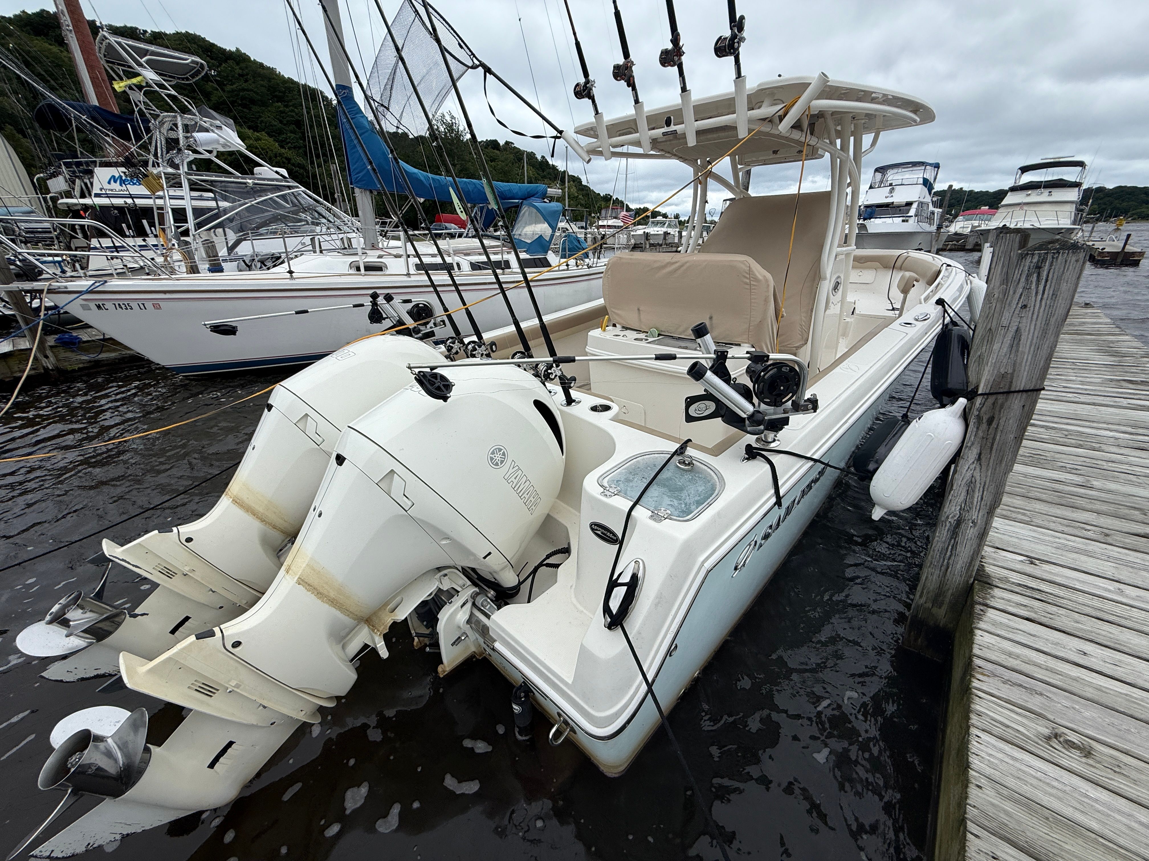 Sailfish 270 CC 2017 Sailfish 270 CC boat docked, featuring dual Yamaha outboard engines and fishing rods.