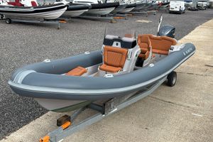 Ribeye A811 2021 Ribeye A811 inflatable boat with orange seating on a trailer.