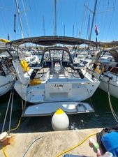 Dufour 37 2024 Dufour 37 yacht docked in marina, rear view with open cockpit and canopy.