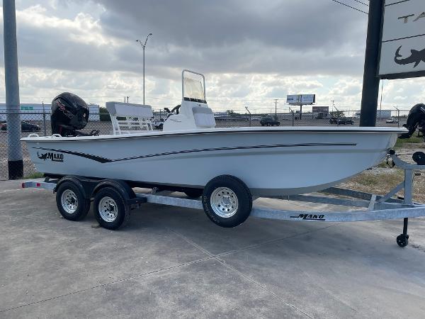 Mako Pro Skiff 19 CC 2025 Mako Pro Skiff 19 CC boat on trailer under cloudy sky.