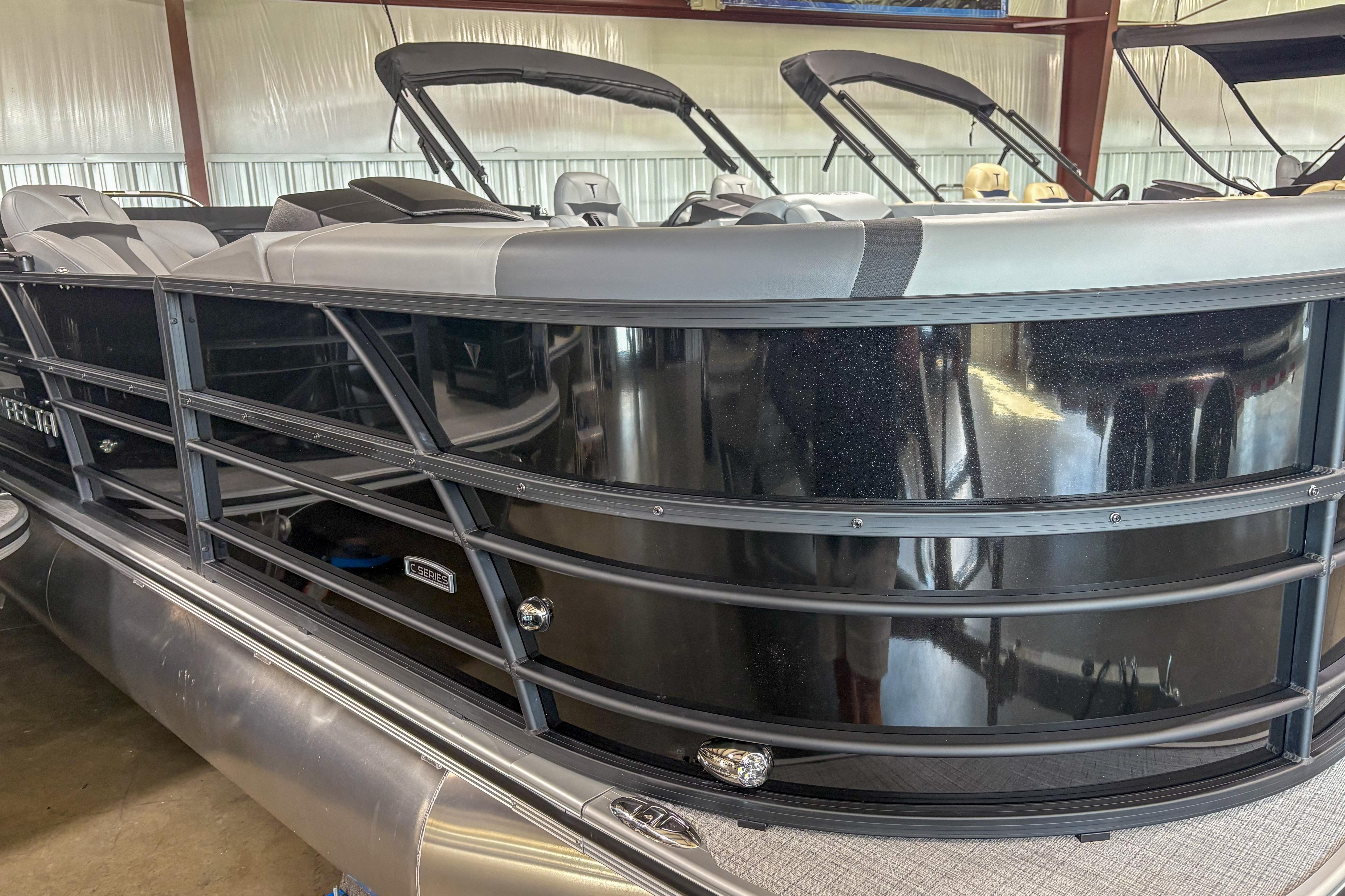Trifecta 24 RF CS 2025 Trifecta 24 RF CS pontoon boat in showroom, featuring sleek black exterior design.
