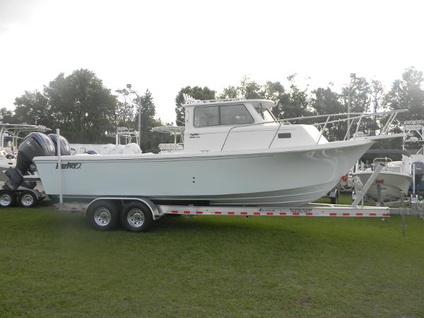 Parker 2820 XLD Sport Cabin 2025 Parker 2820 XLD Sport Cabin boat on trailer, parked on grass.