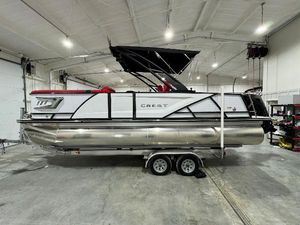 Crest Caribbean RS 230 SLRC 2024 Crest Caribbean RS 230 SLRC pontoon boat in a showroom.