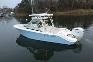 Cobia 240 Dual Console 2024 Cobia 240 Dual Console boat on calm water, featuring Yamaha outboard engine.