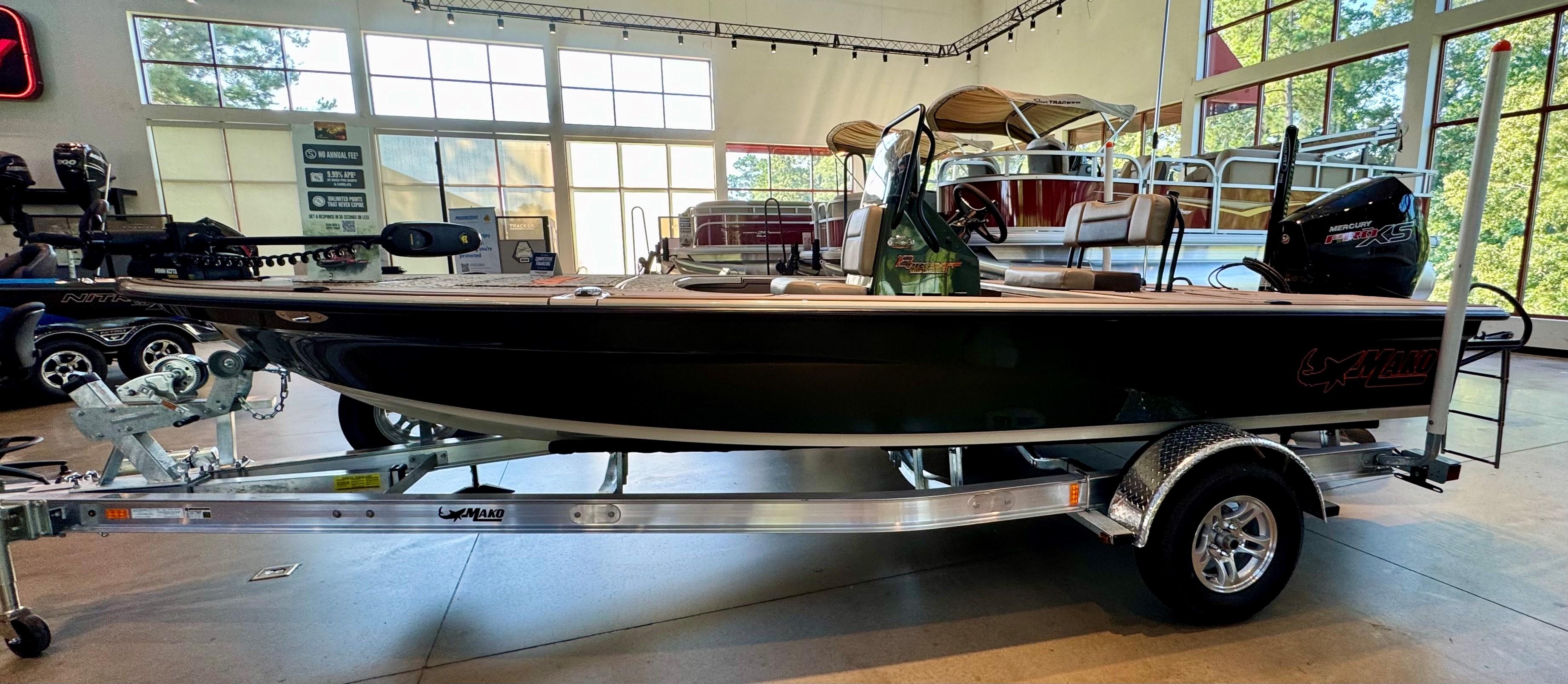 Mako 18 Pro Skiff Backwater Edition 2025 Mako 18 Pro Skiff Backwater Edition boat on trailer in showroom.