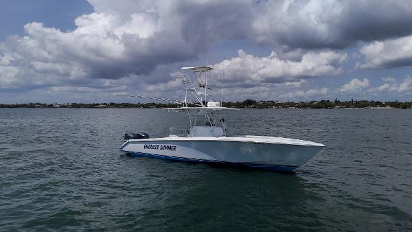 Venture 34 2001 Venture 34 boat on calm water under cloudy sky.