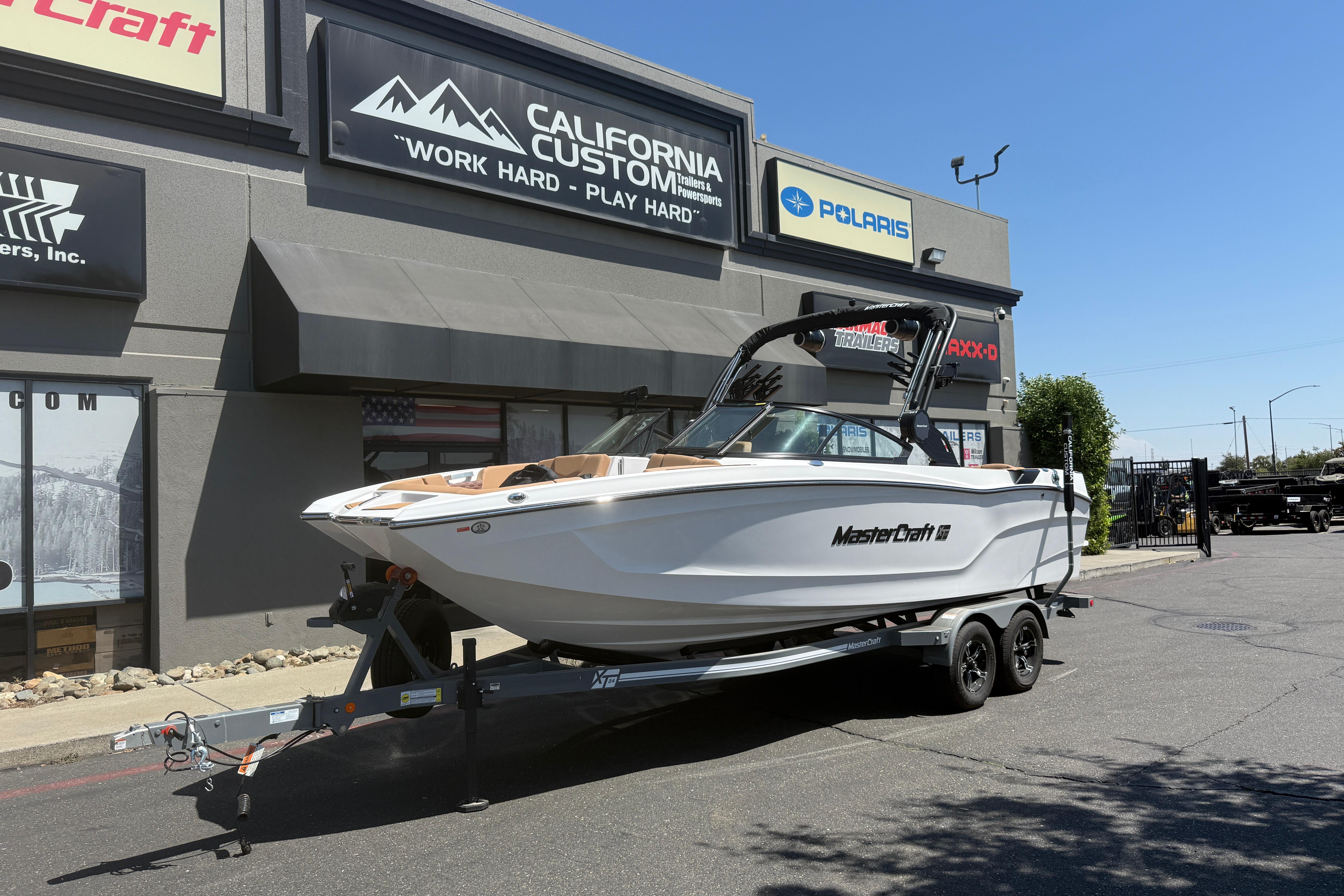 MasterCraft XT24 2025 MasterCraft XT24 boat on trailer outside California Custom store.