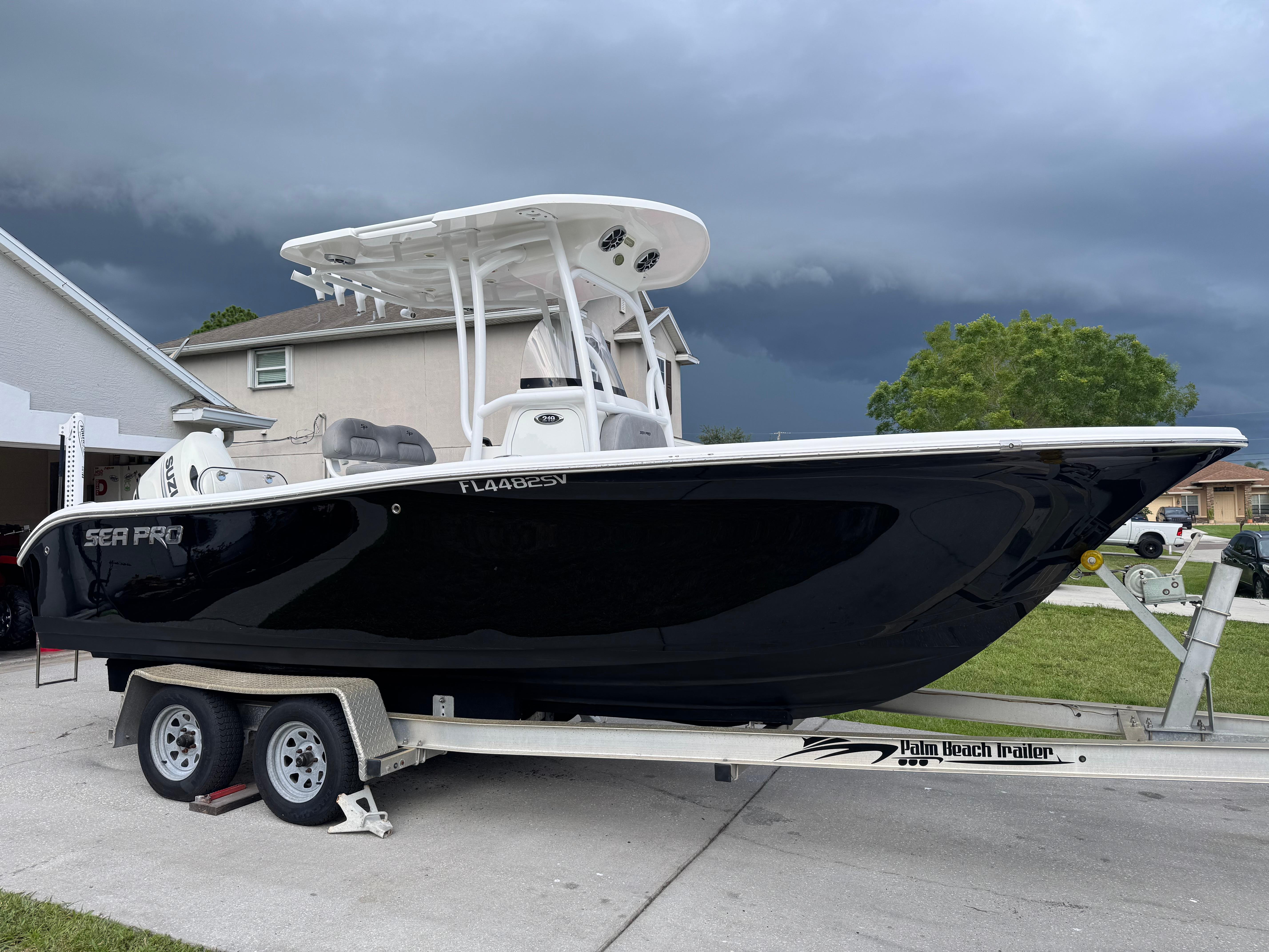 Sea Pro 219 Center Console 2021 Sea Pro 219 Center Console boat on trailer, parked in residential driveway.