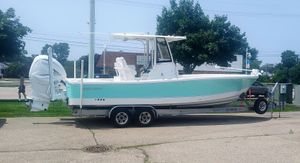 Regulator 26XO 2023 Regulator 26XO boat on trailer, parked outdoors, side view.