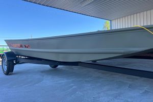 Tracker Grizzly 12 Jon 2026 Tracker Grizzly 12 Jon boat on trailer under a metal roof.