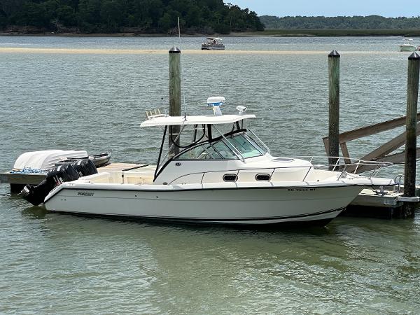 Pursuit 2870 Walkaround 2004 Pursuit 2870 Walkaround boat docked on calm water.