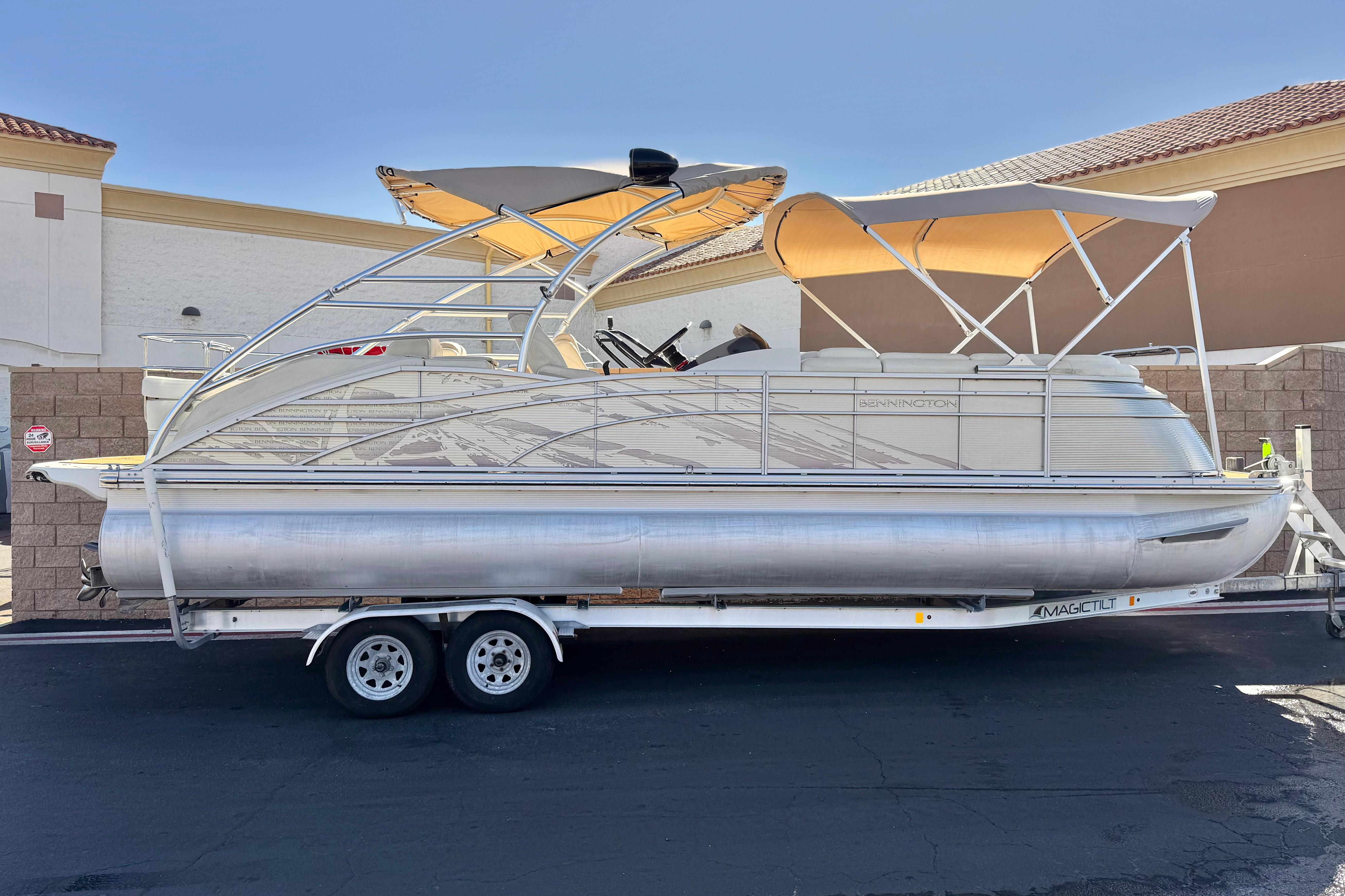 Bennington 2575QCW I/O 2013 Bennington 2575QCW I/O pontoon boat on trailer, featuring dual bimini tops.