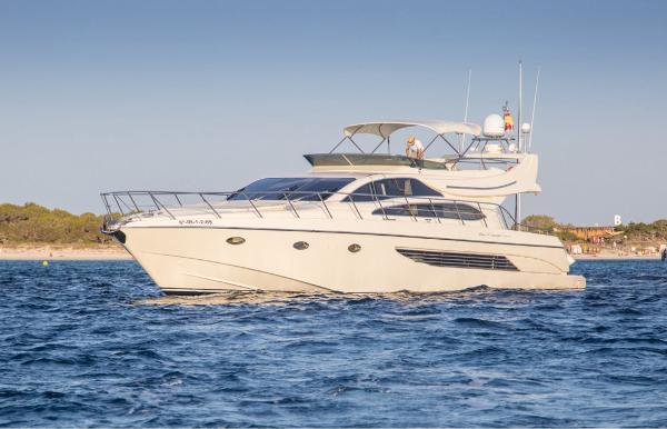Riva 70 Dolcevita Luxury 2004 Riva 70 Dolcevita yacht cruising on serene waters.