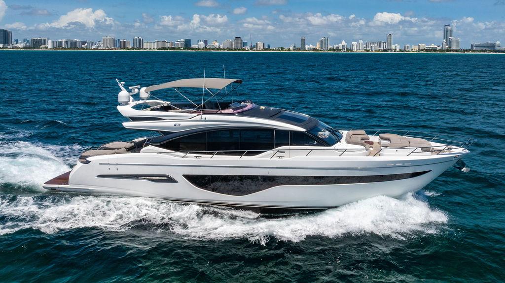 Princess S78 Luxury 2021 Princess S78 yacht cruising on ocean near city skyline.