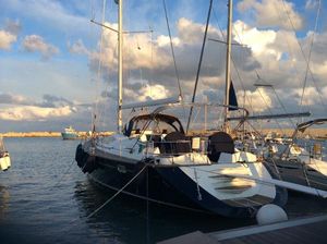 Jeanneau Sun Odyssey 54 DS Jeanneau Sun Odyssey 54 DS 2003 sailboat docked at marina under cloudy sky.