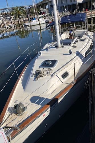 S2 35 CC 1987 S2 35 CC sailboat docked at a marina, featuring a sleek design and spacious deck.
