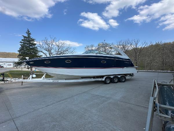Cobalt 360 2005 Cobalt 360 boat on trailer under blue sky with clouds.