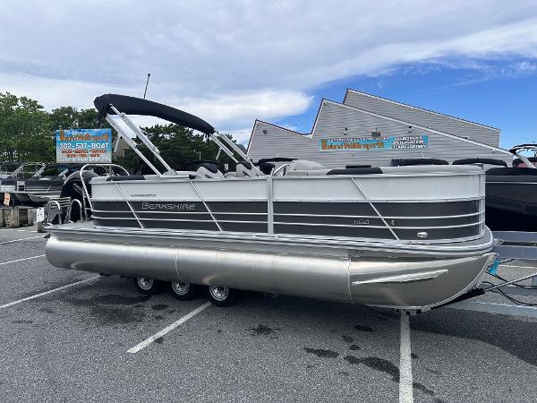 Berkshire 22RFX LE 2.75 2025 Berkshire 22RFX LE 2.75 pontoon boat parked in a lot under a blue sky.