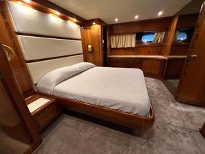 Canados 75 Luxurious bedroom interior of 1987 Canados 75 yacht with elegant wood finishes and ambient lighting.