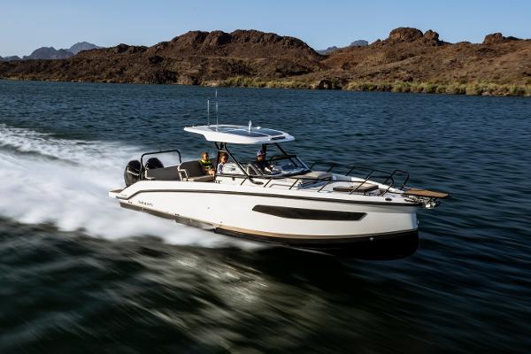 Navan S30 Navan S30 2025 boat cruising on a lake with rocky hills in the background.