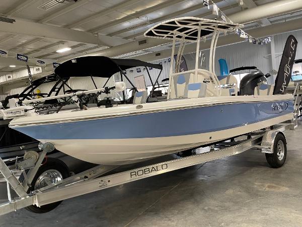 Robalo 206 Cayman 2025 Robalo 206 Cayman boat in showroom, blue and white design on trailer.