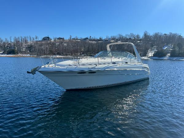 Sea Ray 340 Sundancer 2000 Sea Ray 340 Sundancer boat on calm water under clear blue sky.