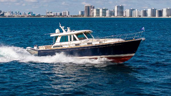 Sabre 48 Salon Express 2015 Sabre 48 Salon Express yacht cruising on blue ocean near city skyline.