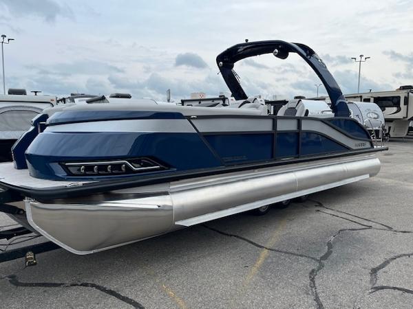Harris Grand Mariner 250 2025 Harris Grand Mariner 250 pontoon boat in a parking lot, showcasing sleek design.