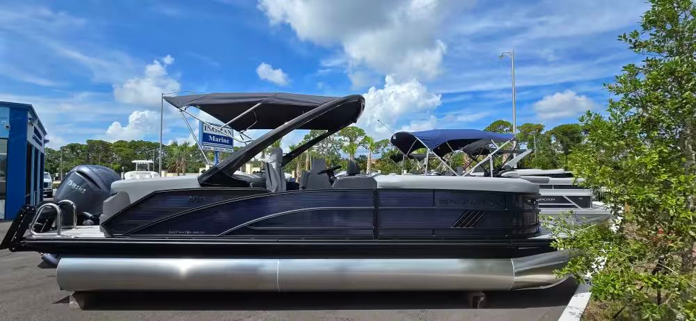 Bennington 24 MFB 2026 Bennington 24 MFB pontoon boat with canopy, parked outdoors under a blue sky.