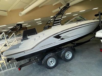 Chaparral 23 SSi 2025 Chaparral 23 SSi boat on trailer in showroom, side view.