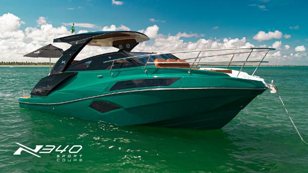 NX Boats NX 340 SPORT COUPE 2025 NX Boats NX340 Sport Coupe on clear water under blue sky.