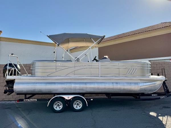 Bennington 23 LSR 2021 Bennington 23 LSR pontoon boat on trailer, parked outdoors.