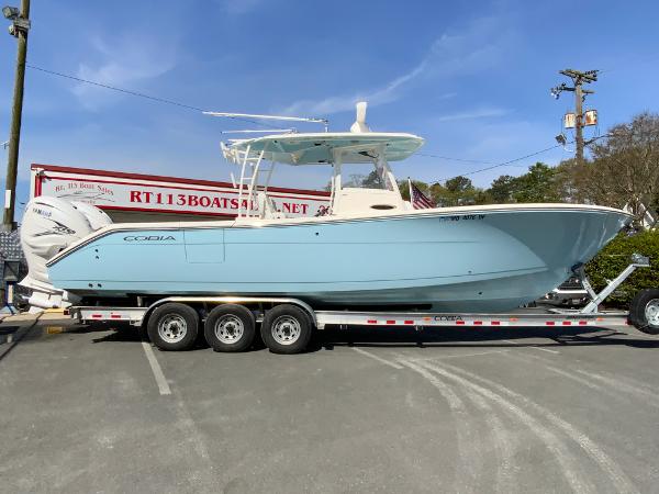 Cobia 320 Center Console 2023 Cobia 320 Center Console boat on a trailer, displayed outdoors.